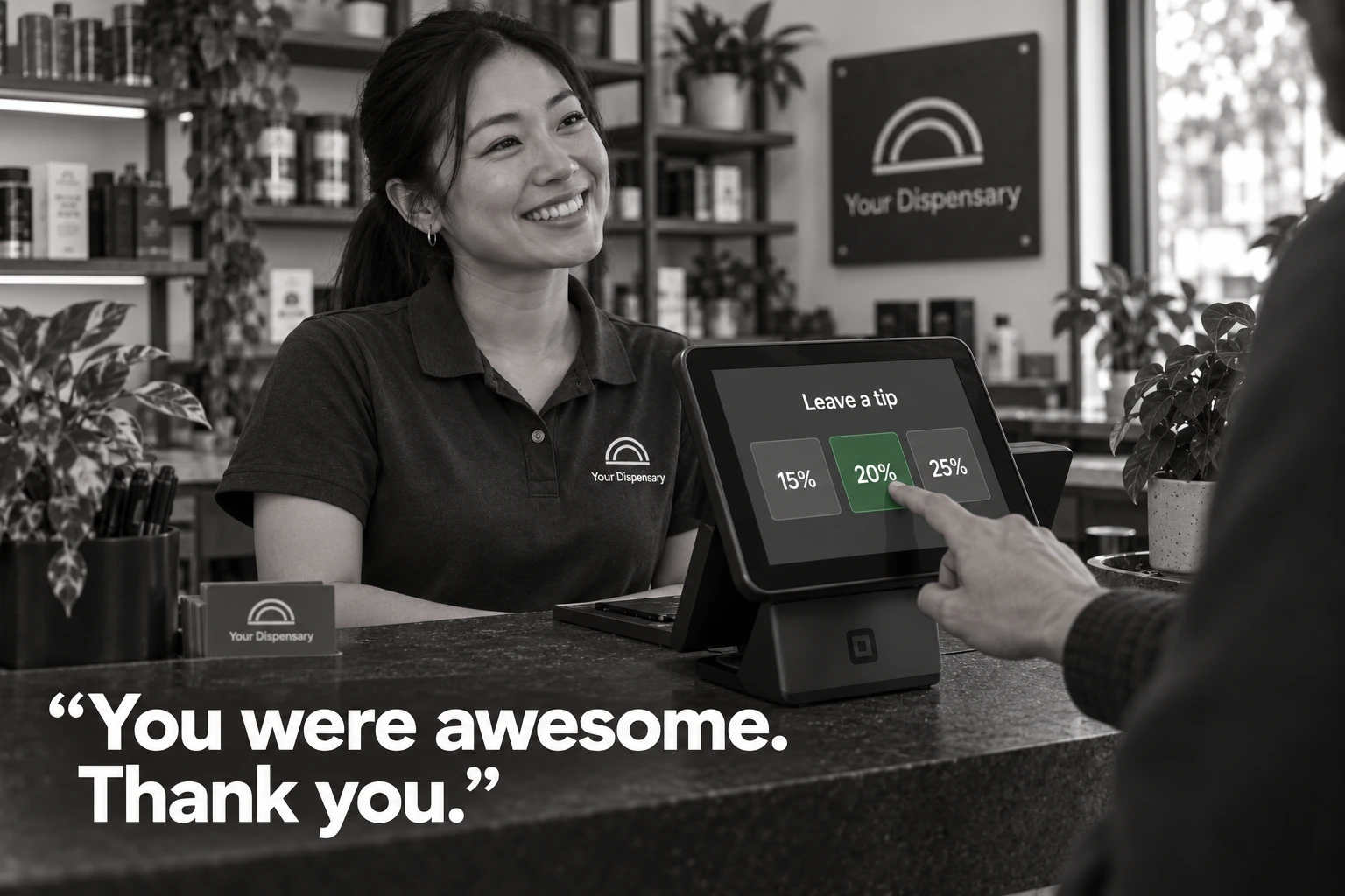 A young professional budtender smiles as a customer selects a green 20 percent tip in an otherwise black-and-white dispensary scene. You were awesome. Thank you.